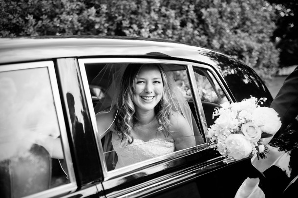 Bride looking out of a vintage car window